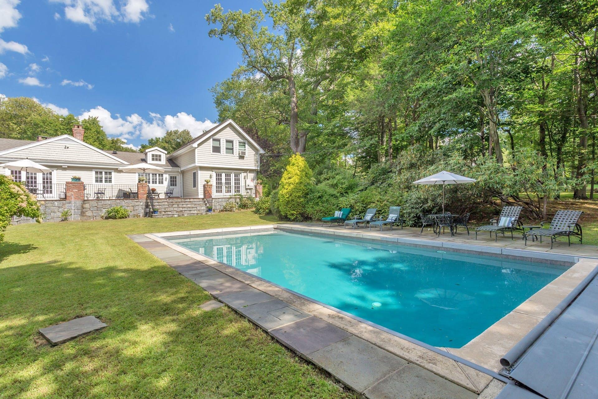 337 Brookside Road Darien, CT 06820 - Photo 2 of 35 a view of swimming pool with a garden and trees