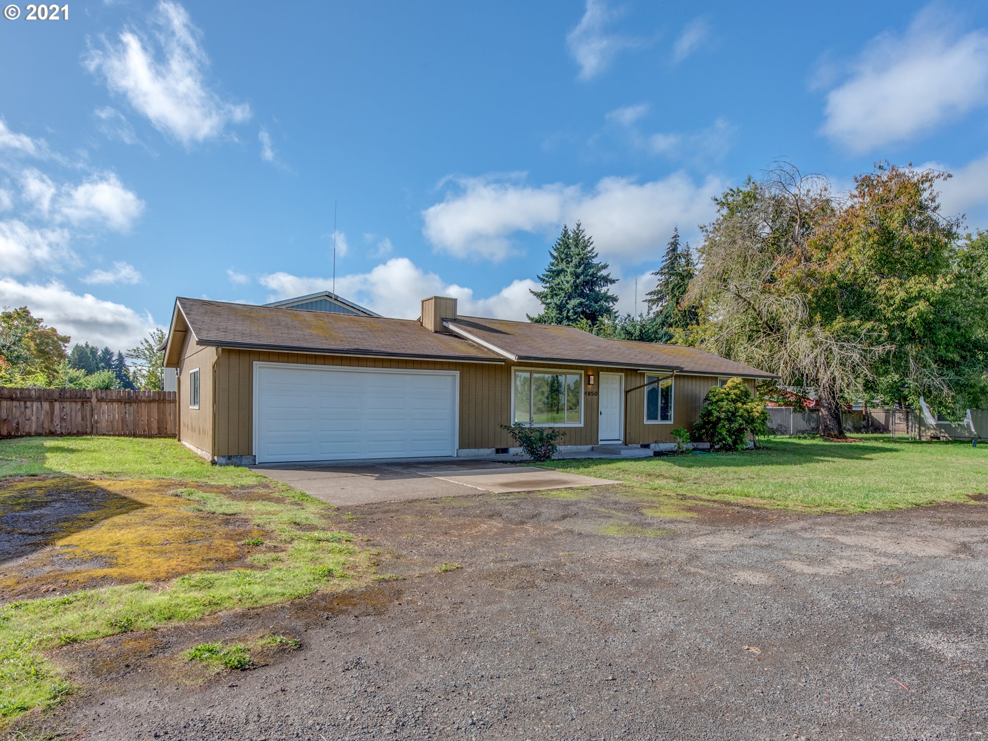 4850 Jessen Drive Eugene, OR 97402 - Photo 1 of 22 a front view of a house with a yard and garage