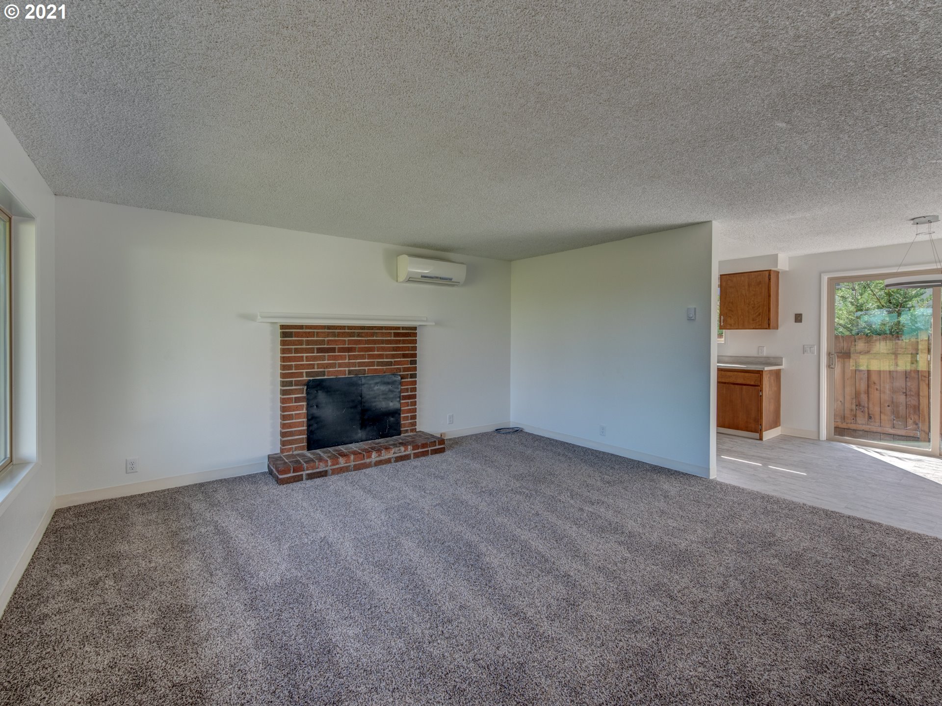 4850 Jessen Drive Eugene, OR 97402 - Photo 7 of 22 an empty room with furniture and a fireplace