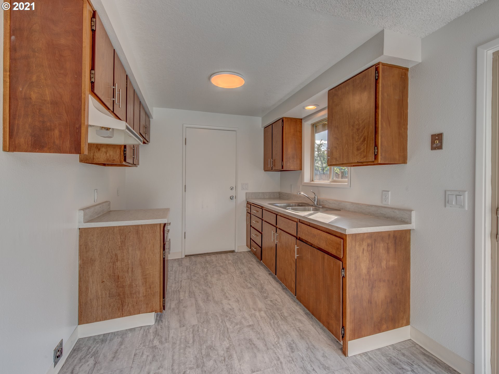 4850 Jessen Drive Eugene, OR 97402 - Photo 9 of 22 a kitchen with a sink a stove and a wooden bench