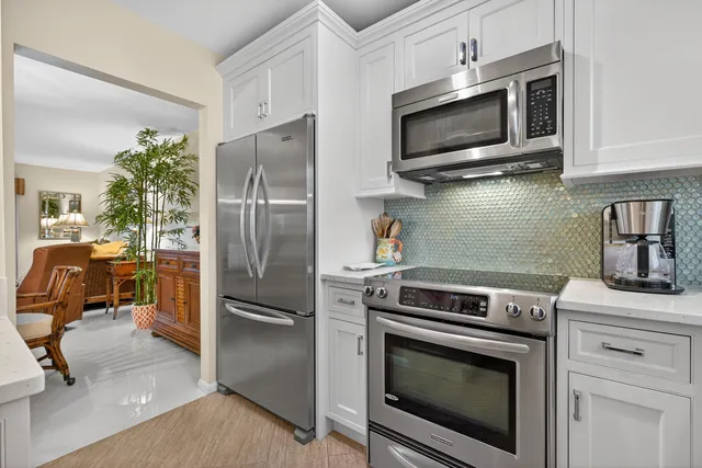 a living room with furniture and a dining table with kitchen view