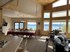 1940 East Shore Road St. Charles, ID 83272 - Photo 15 of 64 Living area featuring a vaulted wooden ceiling, suspended lighting, and light colored carpet