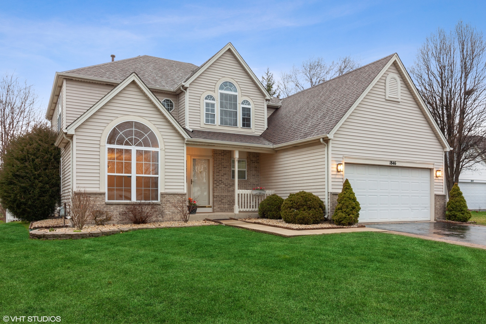 a front view of a house with a garden