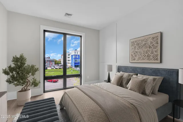 a bedroom with bed and balcony