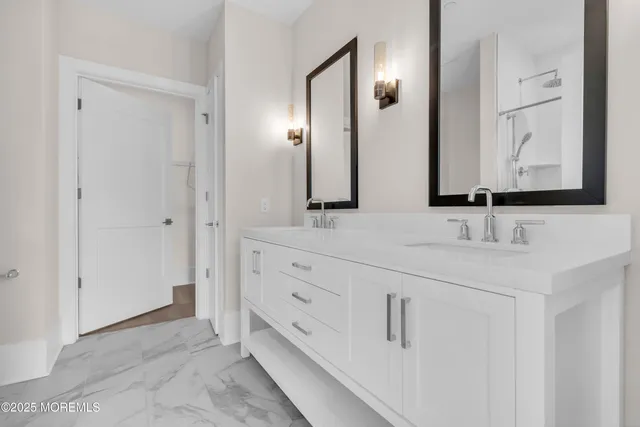 a bathroom with double sink and a mirror