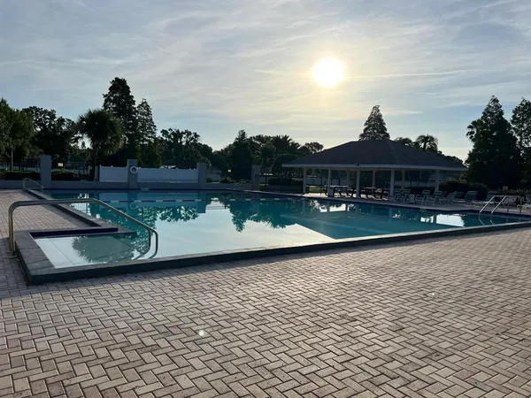 swimming pool view with a seating space