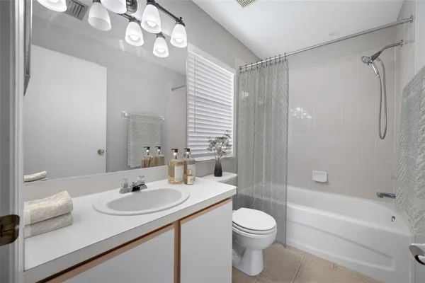 a bathroom with a sink toilet tub and shower