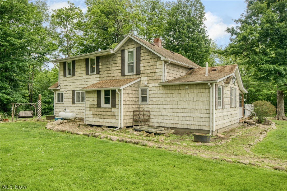 15221 Thompson Road Thompson, OH 44086 - Photo 26 of 31 Rear view of property featuring a lawn