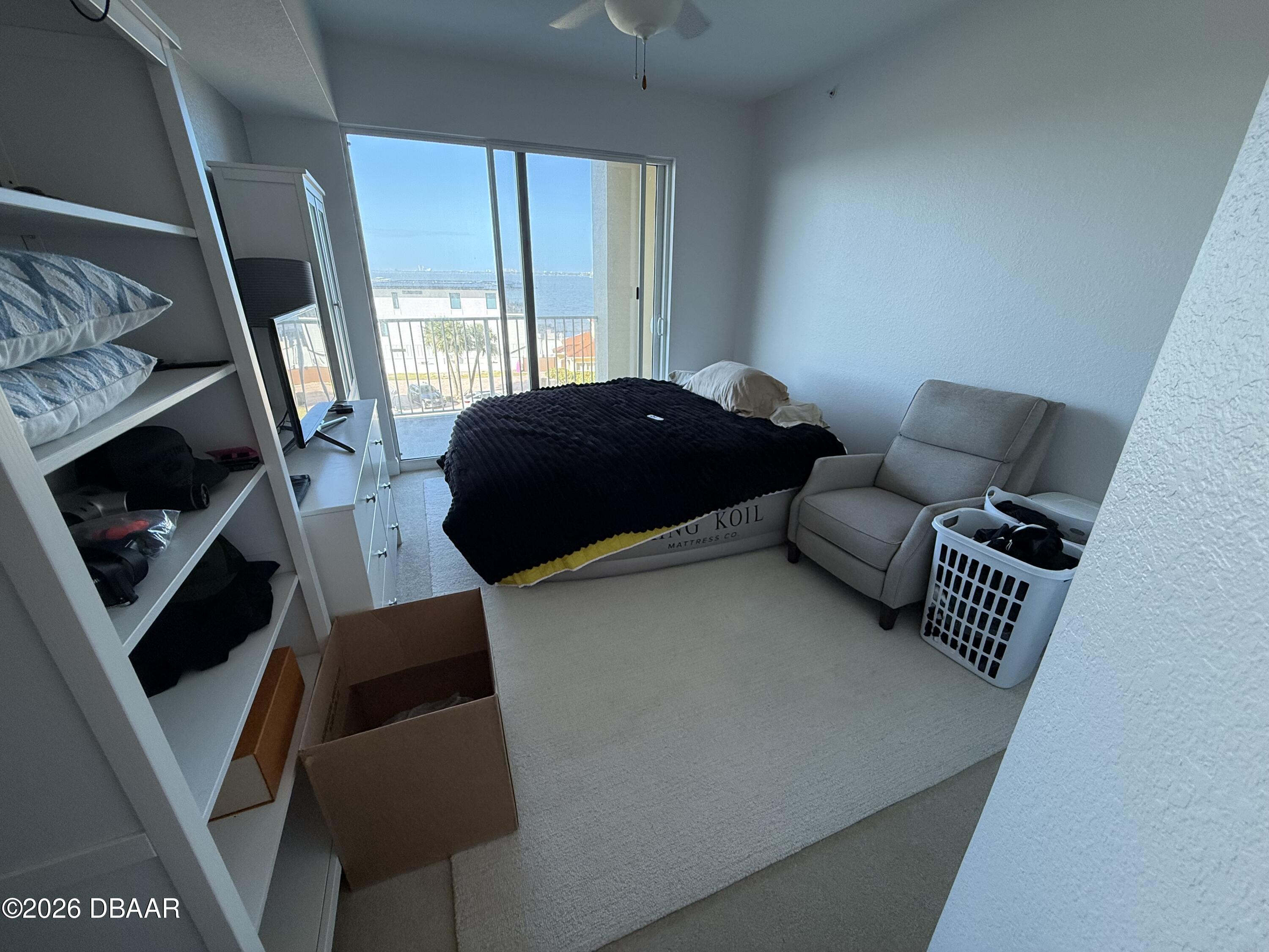 2801 South Ridgewood Avenue, Unit 409 South Daytona, FL 32119 - Photo 17 of 23 a bedroom with a bed and a window