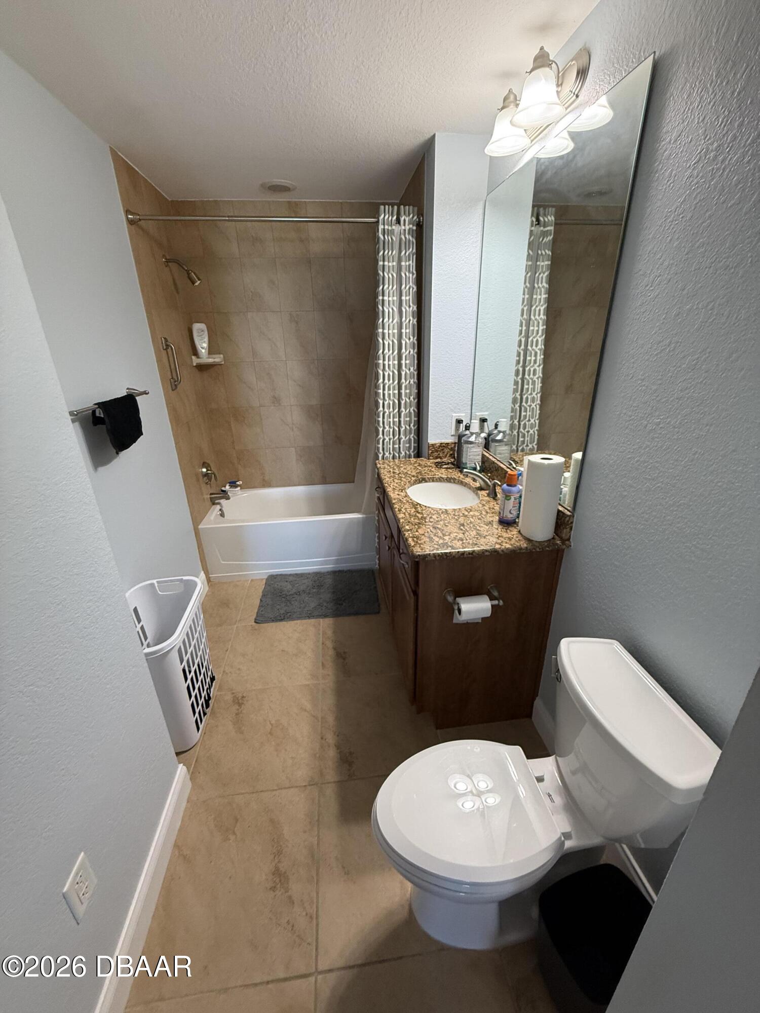 2801 South Ridgewood Avenue, Unit 409 South Daytona, FL 32119 - Photo 19 of 23 a bathroom with a toilet sink and mirror or bathtub