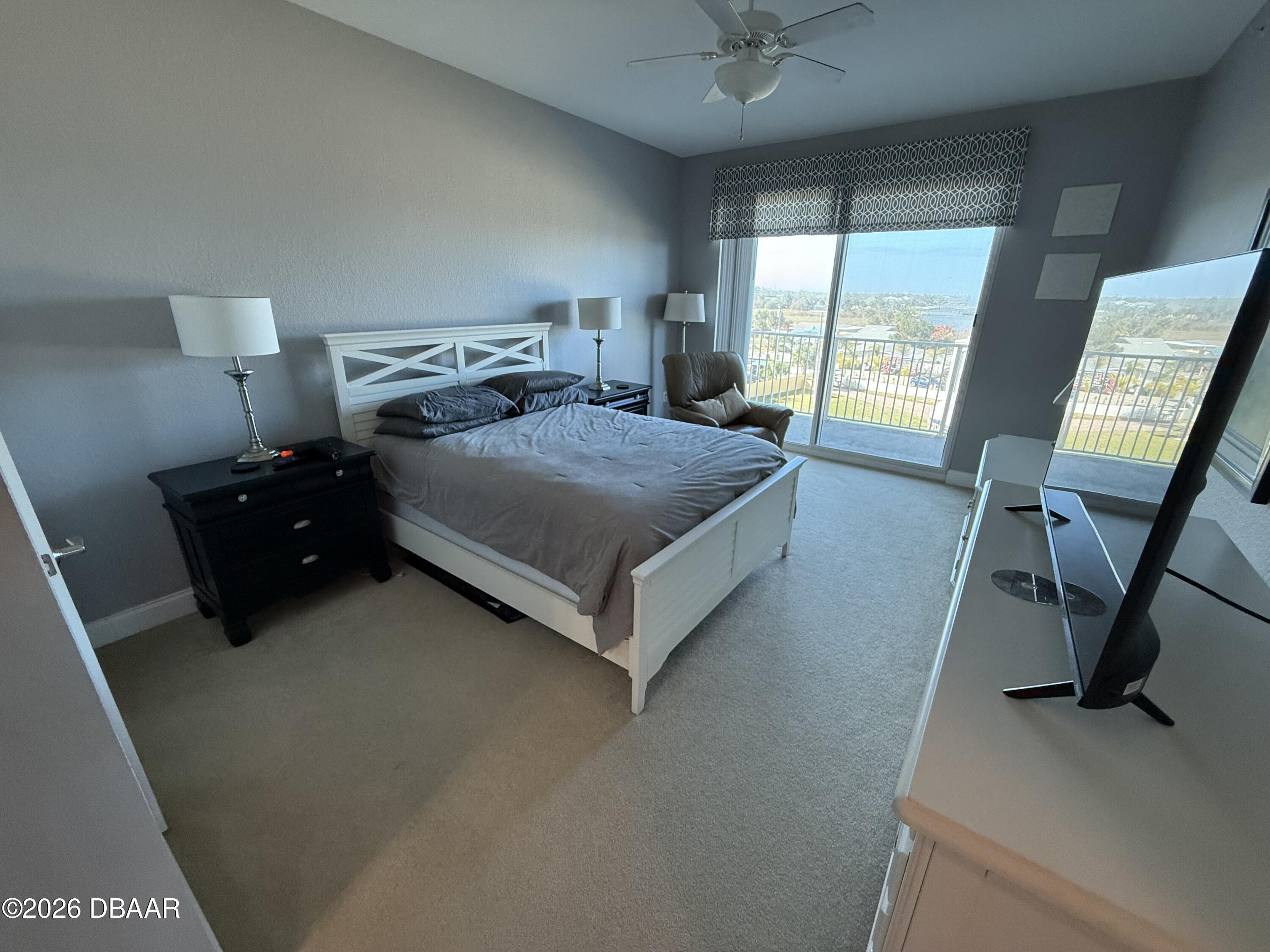 2801 South Ridgewood Avenue, Unit 409 South Daytona, FL 32119 - Photo 20 of 23 a bedroom with a bed window and a desk