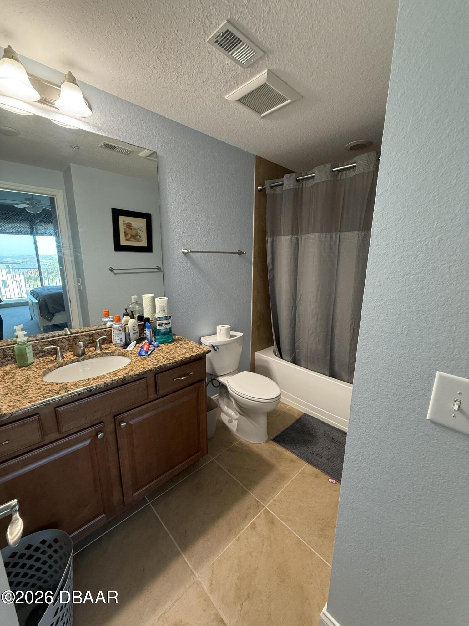 2801 South Ridgewood Avenue, Unit 409 South Daytona, FL 32119 - Photo 22 of 23 a spacious bathroom with a double vanity sink toilet and a mirror