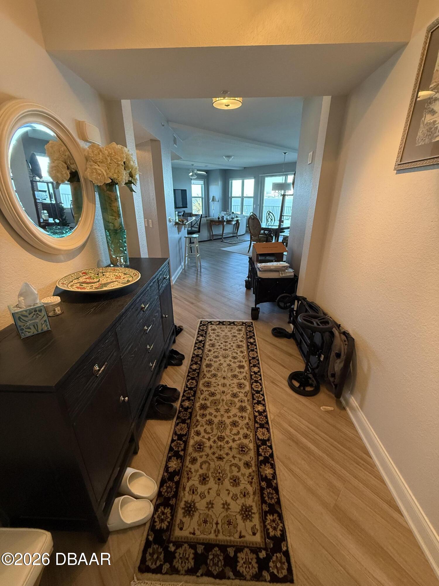 2801 South Ridgewood Avenue, Unit 409 South Daytona, FL 32119 - Photo 3 of 23 a hallway with sitting area and mirrors