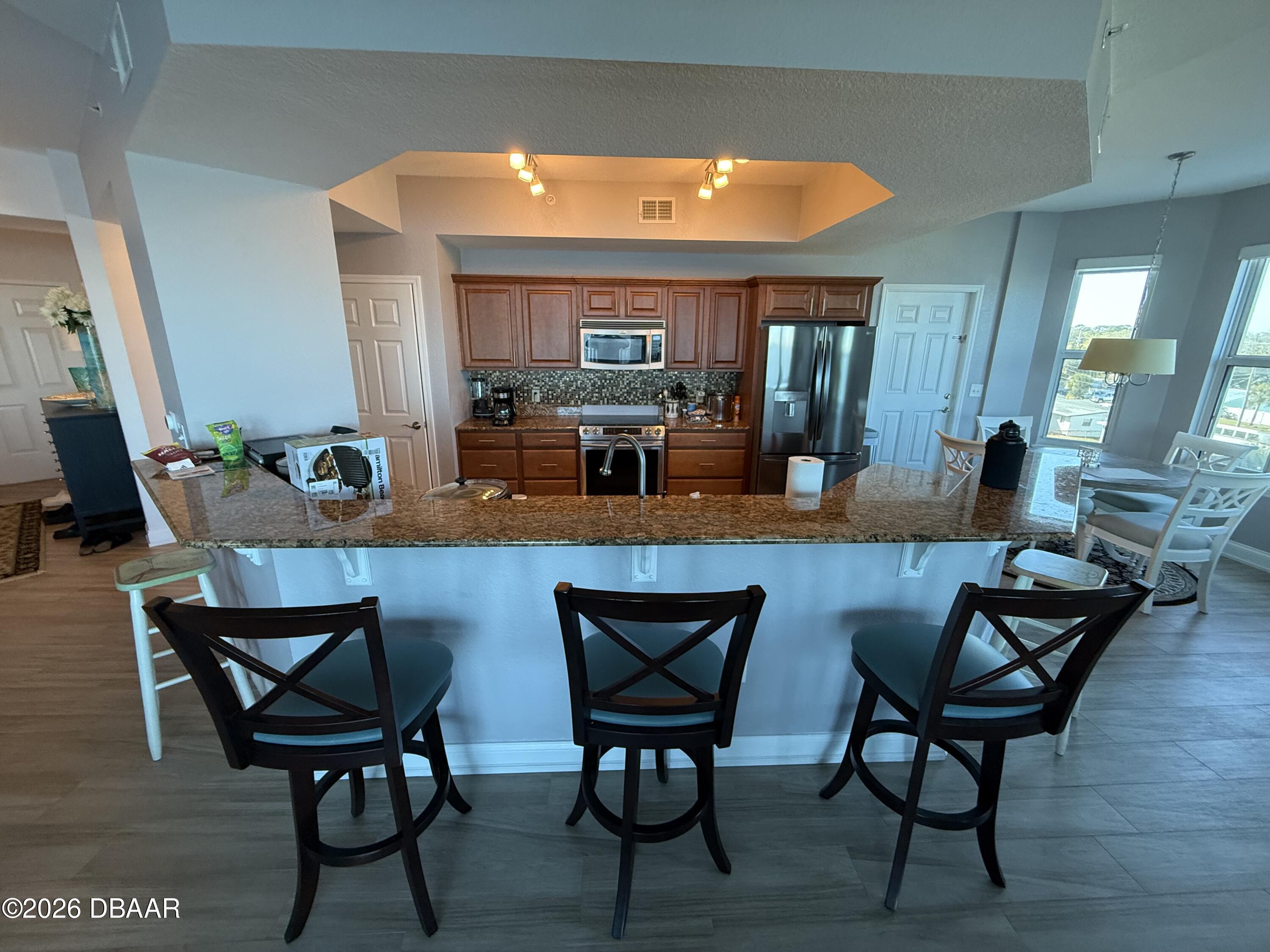 2801 South Ridgewood Avenue, Unit 409 South Daytona, FL 32119 - Photo 7 of 23 a view of a dining room with furniture