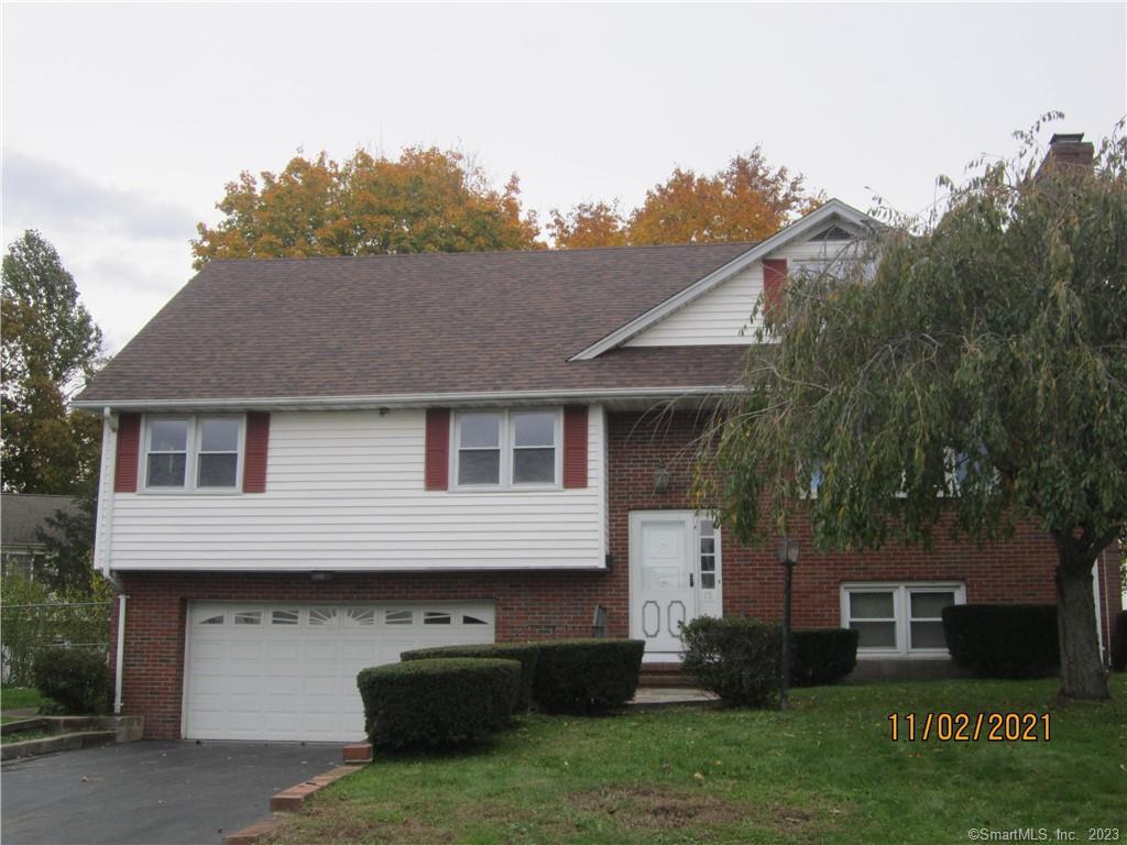 75 David Drive Meriden, CT 06450 - Photo 1 of 1 a front view of a house with a garden and plants