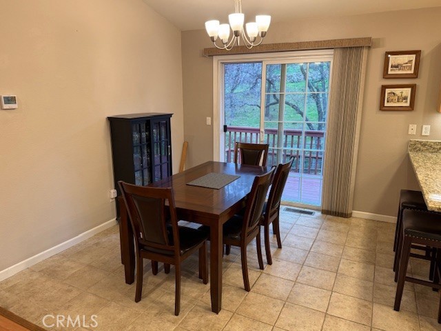 18992 Redbud Road Hidden Valley Lake, CA 95467 - Photo 12 of 39 a view of a dining room with furniture window and outside view