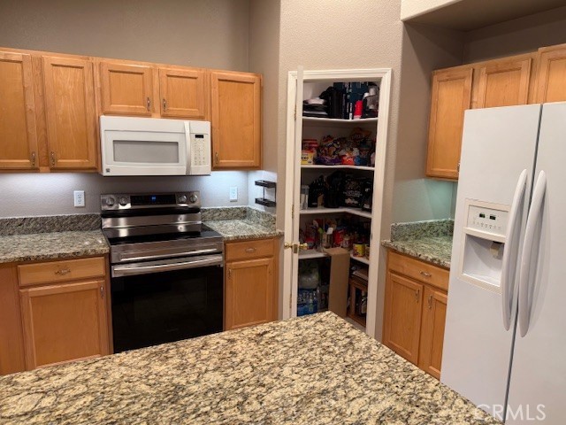 18992 Redbud Road Hidden Valley Lake, CA 95467 - Photo 14 of 39 a kitchen with stainless steel appliances granite countertop a sink stove and refrigerator