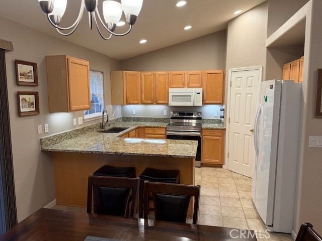 18992 Redbud Road Hidden Valley Lake, CA 95467 - Photo 16 of 39 a kitchen with stainless steel appliances granite countertop a sink a stove a refrigerator a microwave a dining table and chairs