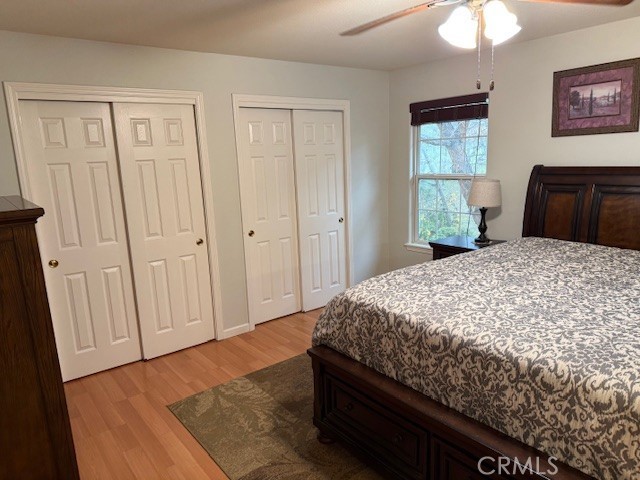 18992 Redbud Road Hidden Valley Lake, CA 95467 - Photo 20 of 39 a bedroom with a bed cabinet and a window