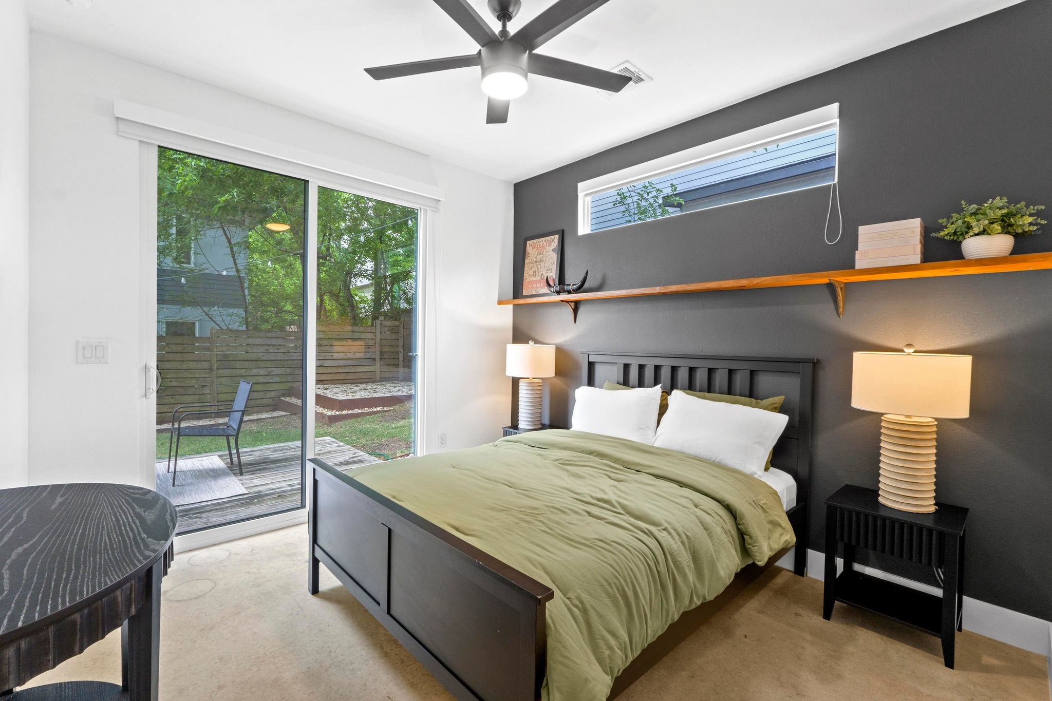 1706 Perez Street, Unit 2 Austin, TX 78721 - Photo 14 of 29 A well-lit bedroom with modern design, featuring a sliding glass door to a private yard.