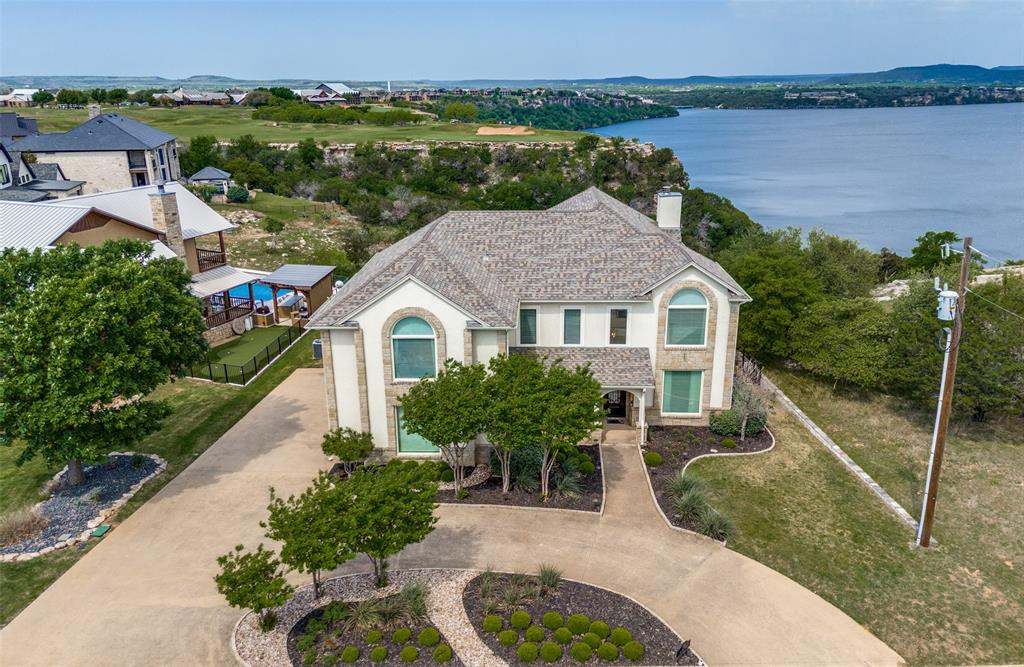 a aerial view of a house with a yard and a fountain