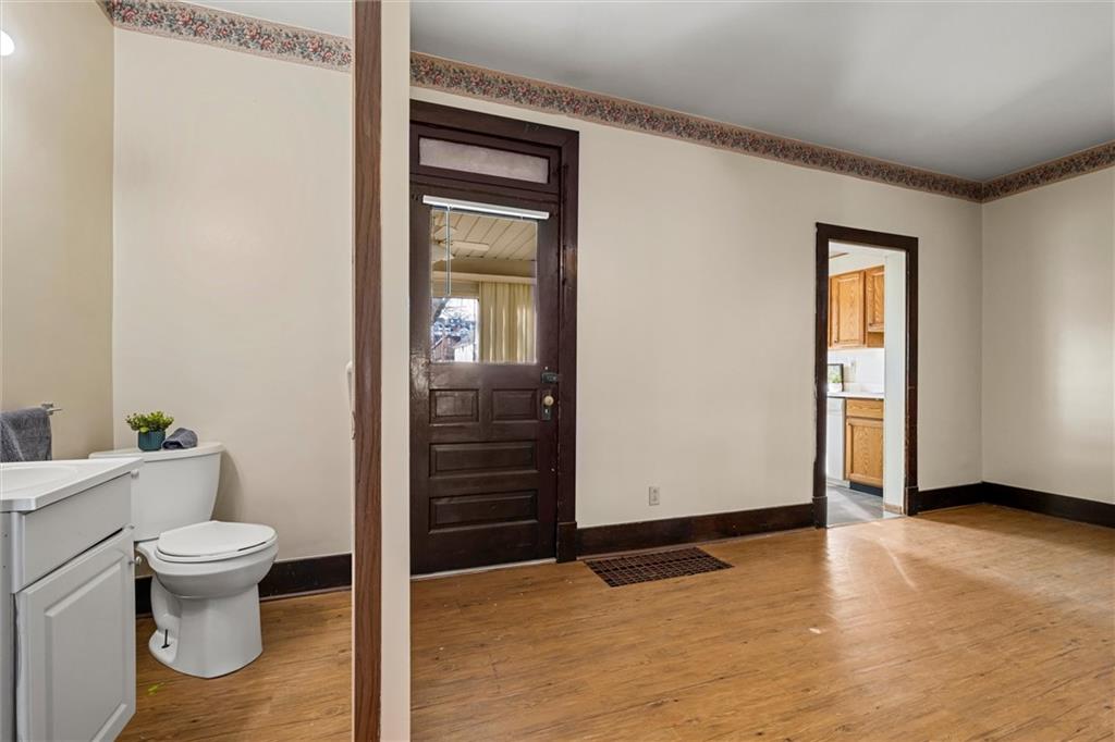 325 Walnut Street Vandergrift, PA 15690 - Photo 9 of 29 a view of an empty room with wooden floor and a window