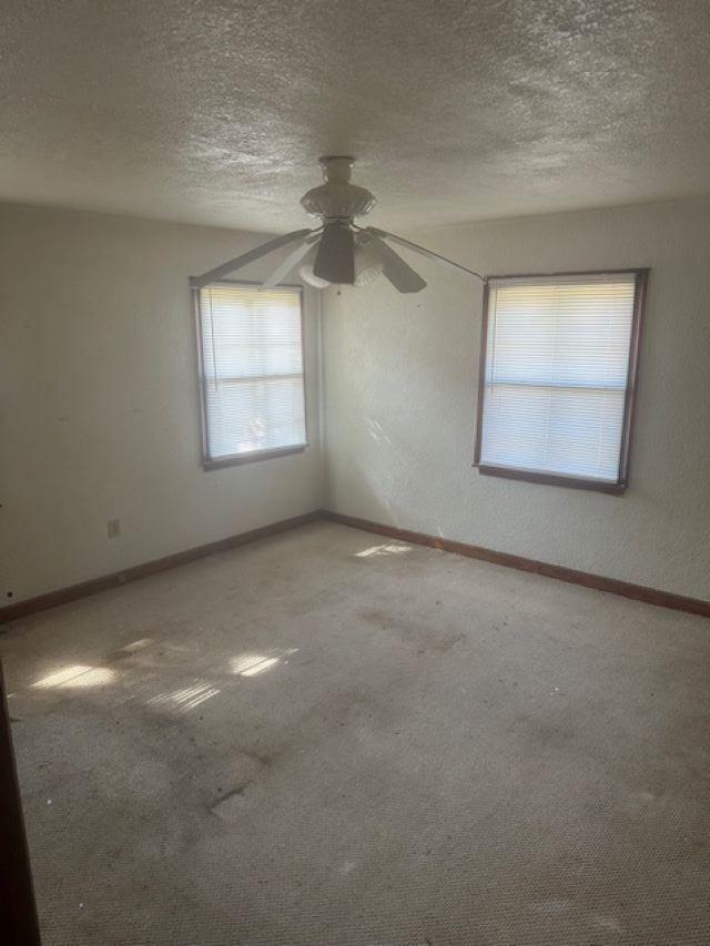 373 Washington Street Ripley, TN 38063 - Photo 17 of 19 an empty room with a window and a ceiling fan