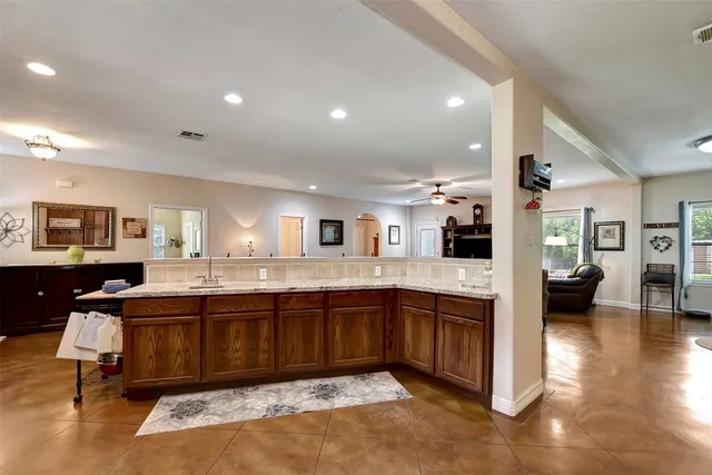a large kitchen with lots of counter and sink