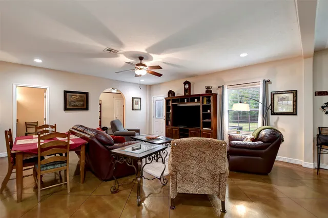 a living room with furniture a dining table and a fireplace