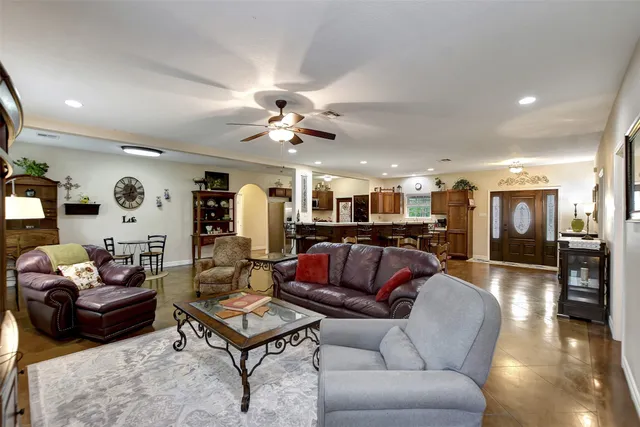 a living room with furniture a flat screen tv and a window