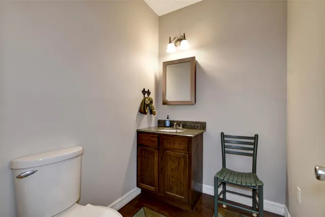a bath room with a table and a chandelier