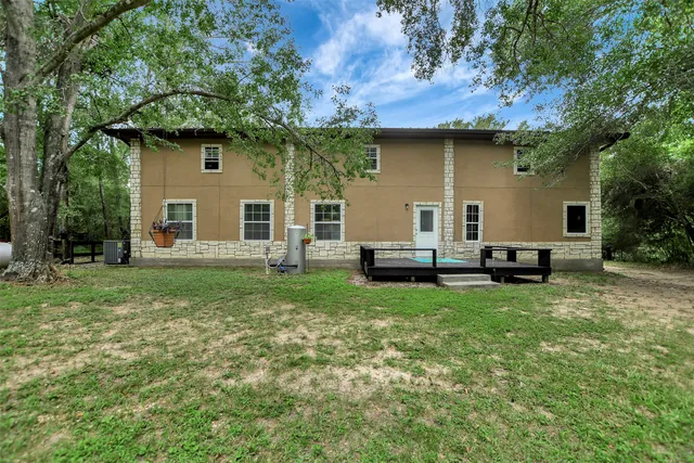 a view of a backyard with table and chairs and potted plants