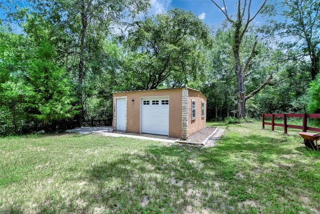 a view of a backyard with large trees