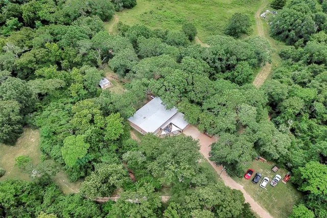 an aerial view of a house with a yard