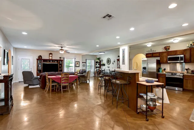 a living room with lots of furniture and kitchen