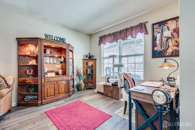 a view of a workspace with furniture and wooden floor