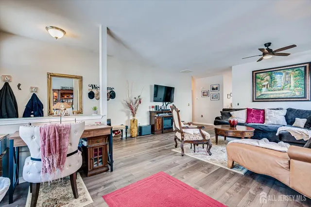 a living room with furniture and wooden floor