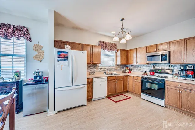 a kitchen with granite countertop stainless steel appliances and white cabinets