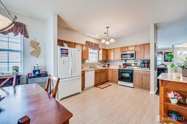 a kitchen with stainless steel appliances a stove refrigerator sink and cabinets