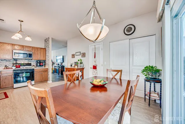 an open kitchen with dining table and chairs