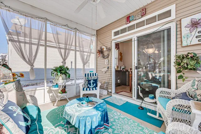 a living room with patio furniture and a large window