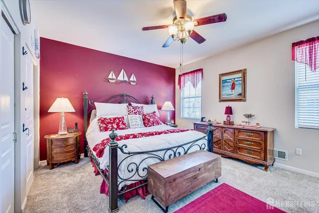 a bedroom with bed and a chandelier