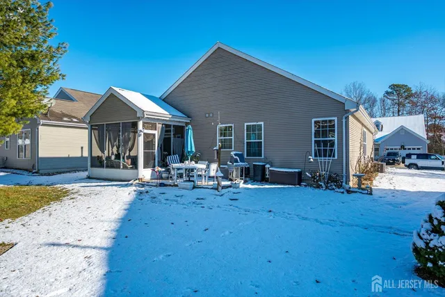 a view of a house with backyard sitting area and garden