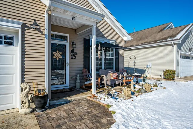a group of people sitting in front of a house