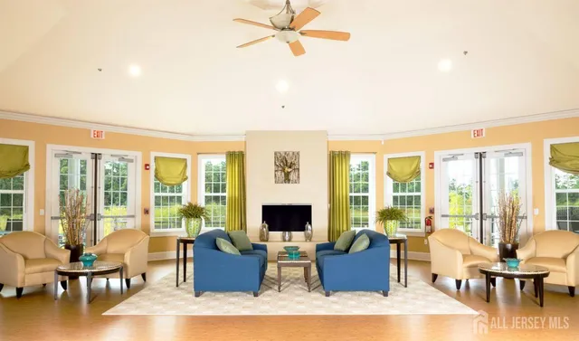 a living room with furniture and floor to ceiling windows