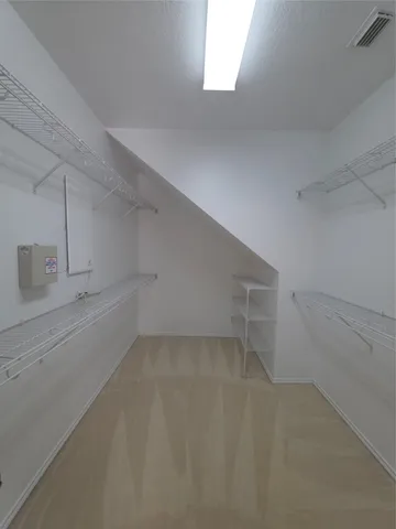 a view of a storage and utility room with empty racks