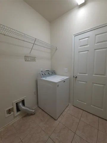 a utility room with cabinets washer and dryer