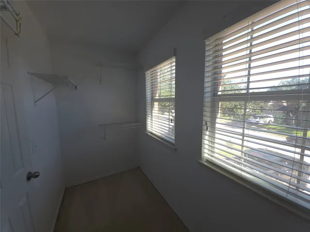 a view of an empty room with a fan