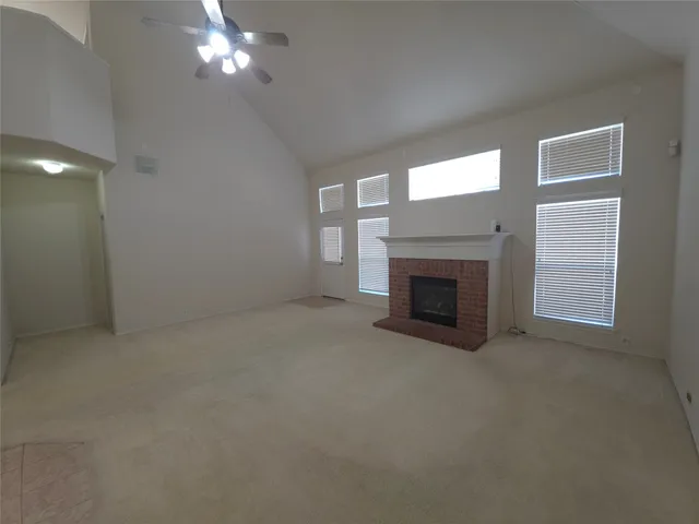 a view of empty room with a fireplace