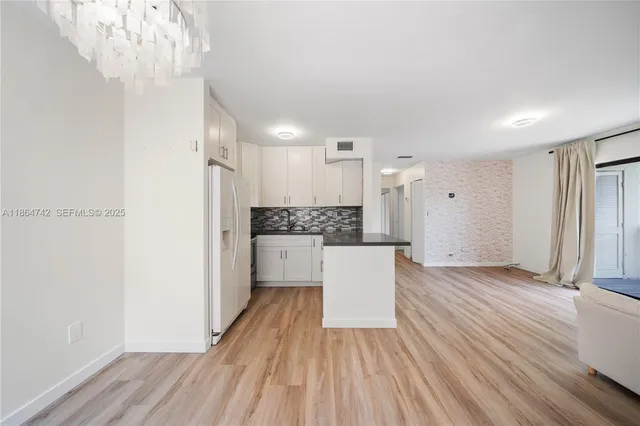 a view of kitchen with cabinets and wooden floor